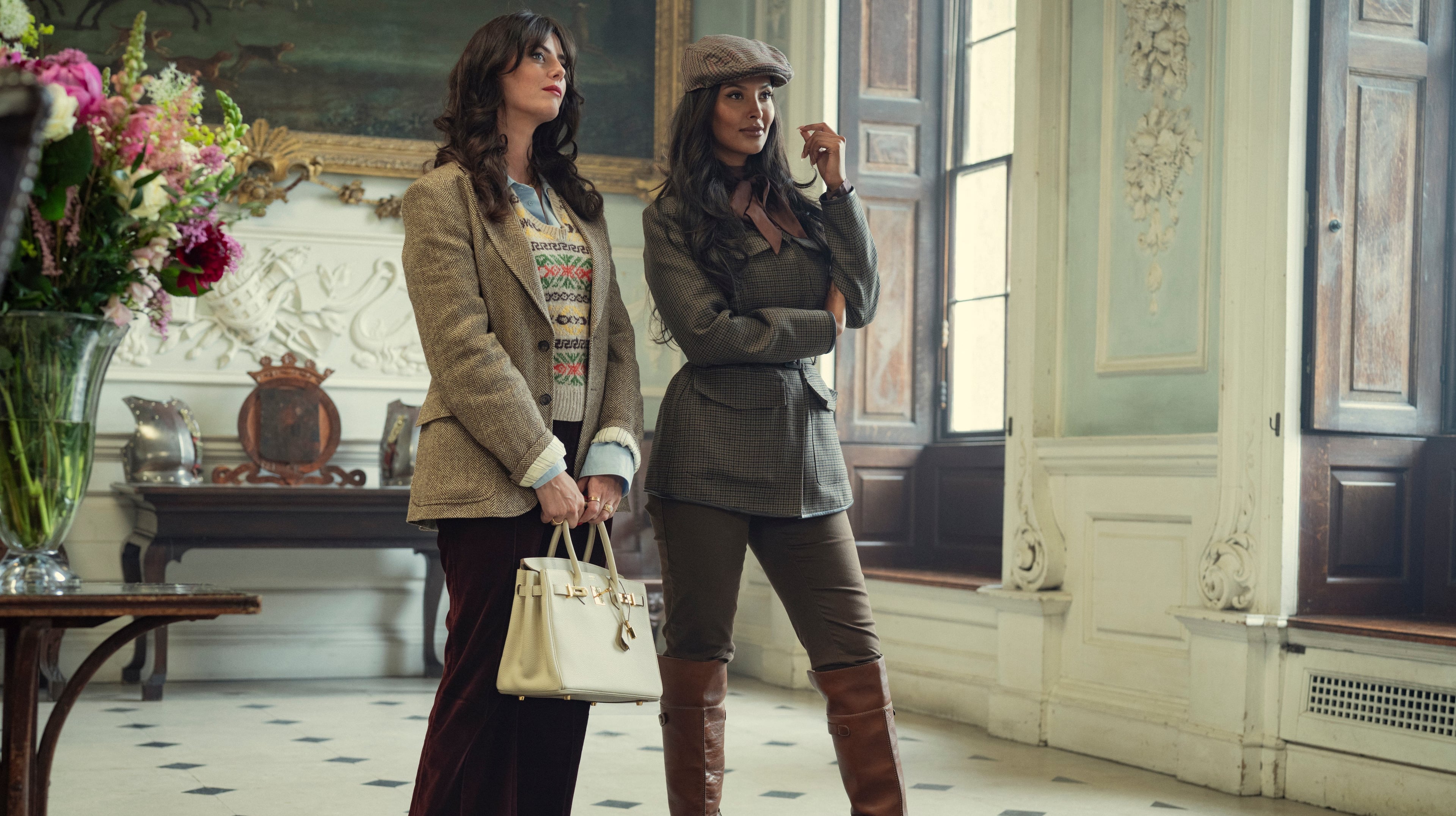 Susie (Kaya Scodelario) and Aisha (Maya Jama) in "The Gentlemen" season two.