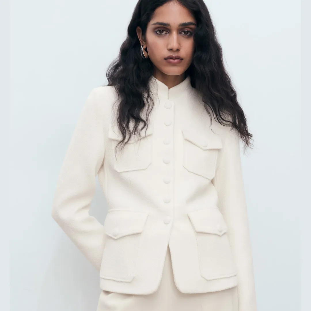 A model wears the Mango Bouclé jacket with pockets in white