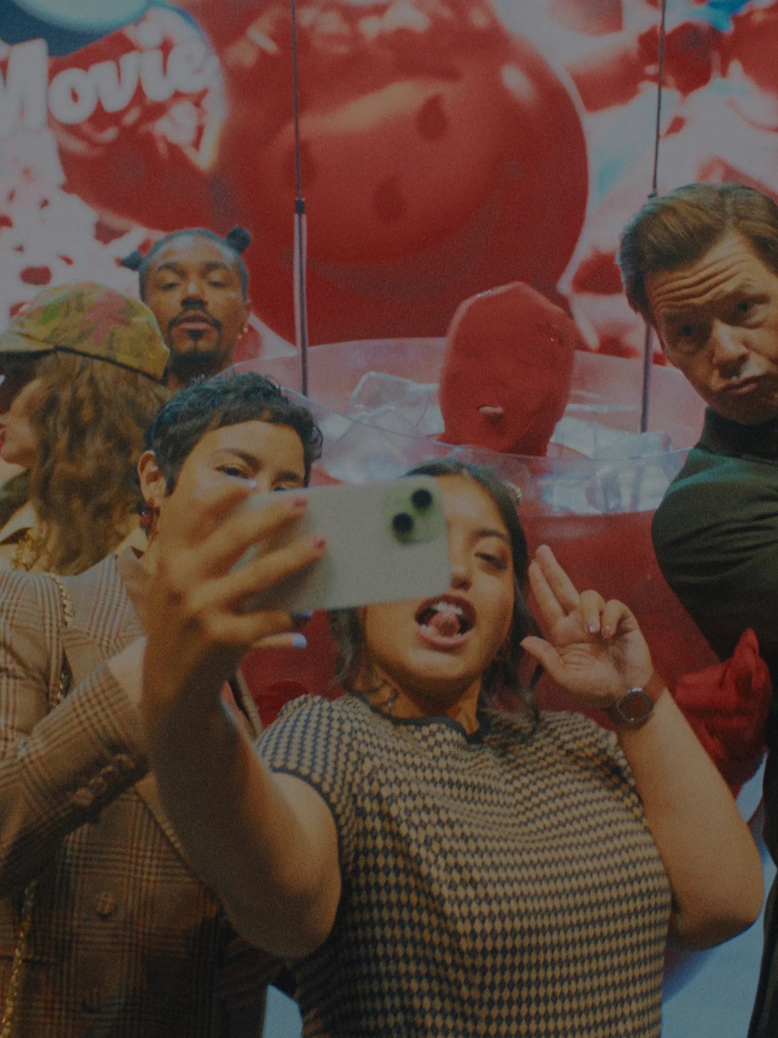 Actors Chase Sui Wonders and Ike Barinholtz take a selfie with another actor on set of "The Studio" TV show.