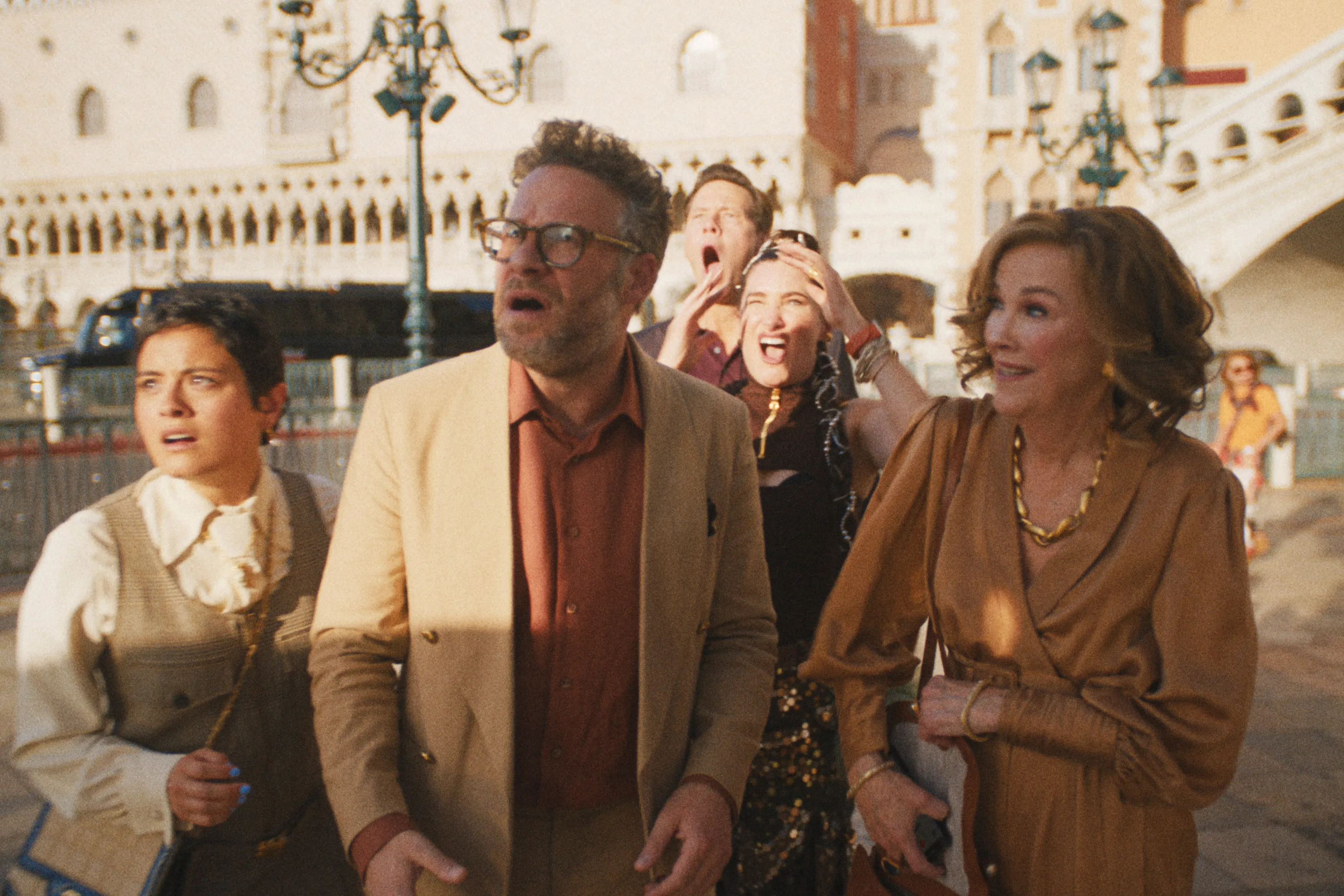 The cast of "The Studio" standing together outside in Venice, Italy, with expressions of shock on their faces.