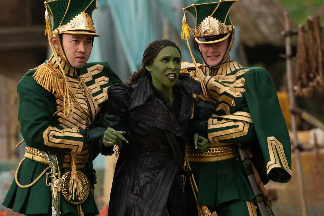 Cynthia Erivo as Elphaba being held by two guards, in a still from Wicked: For Good.