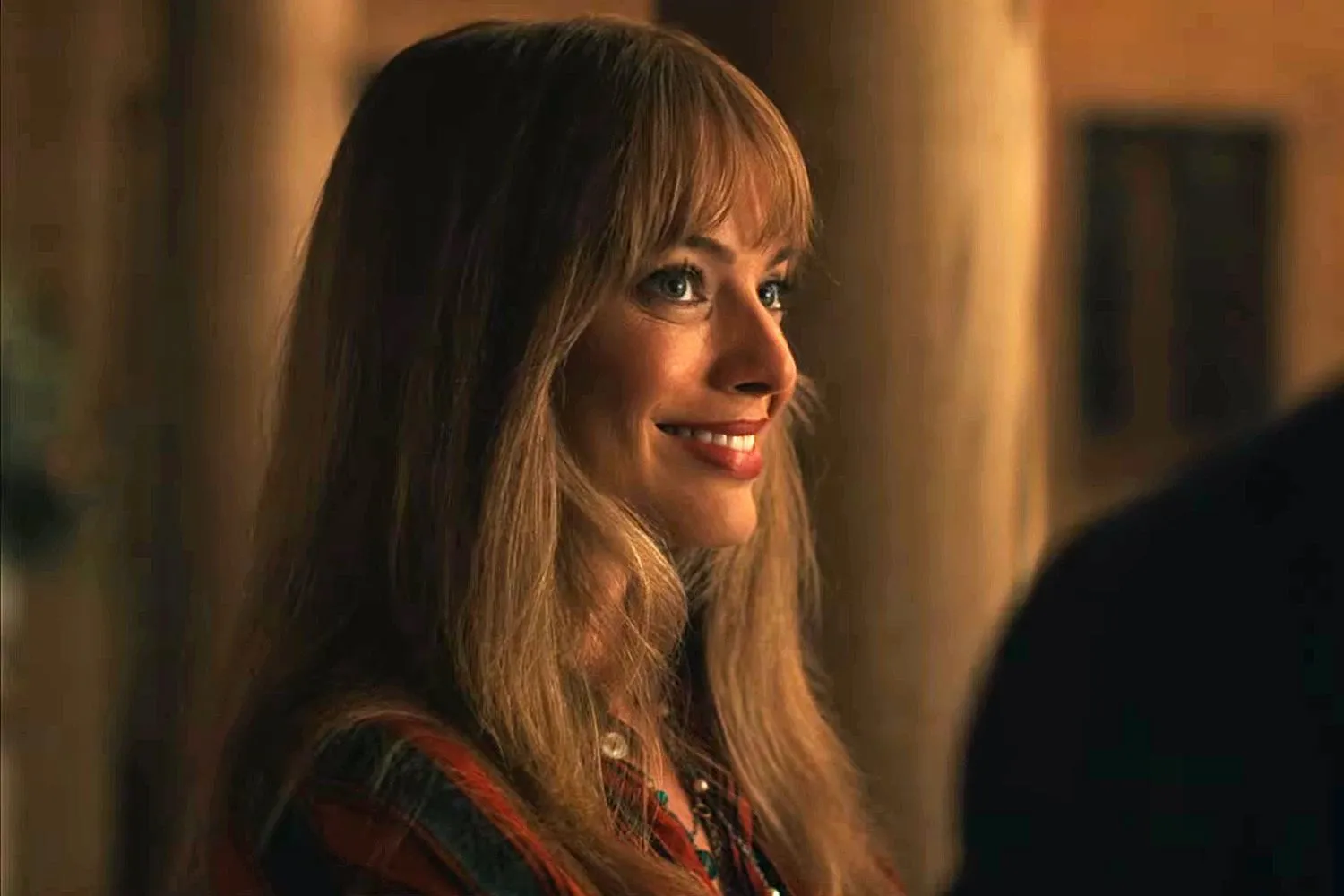Margot Robbie smiles at something in front of her in a still from "A Big Bold Beautiful Journey."