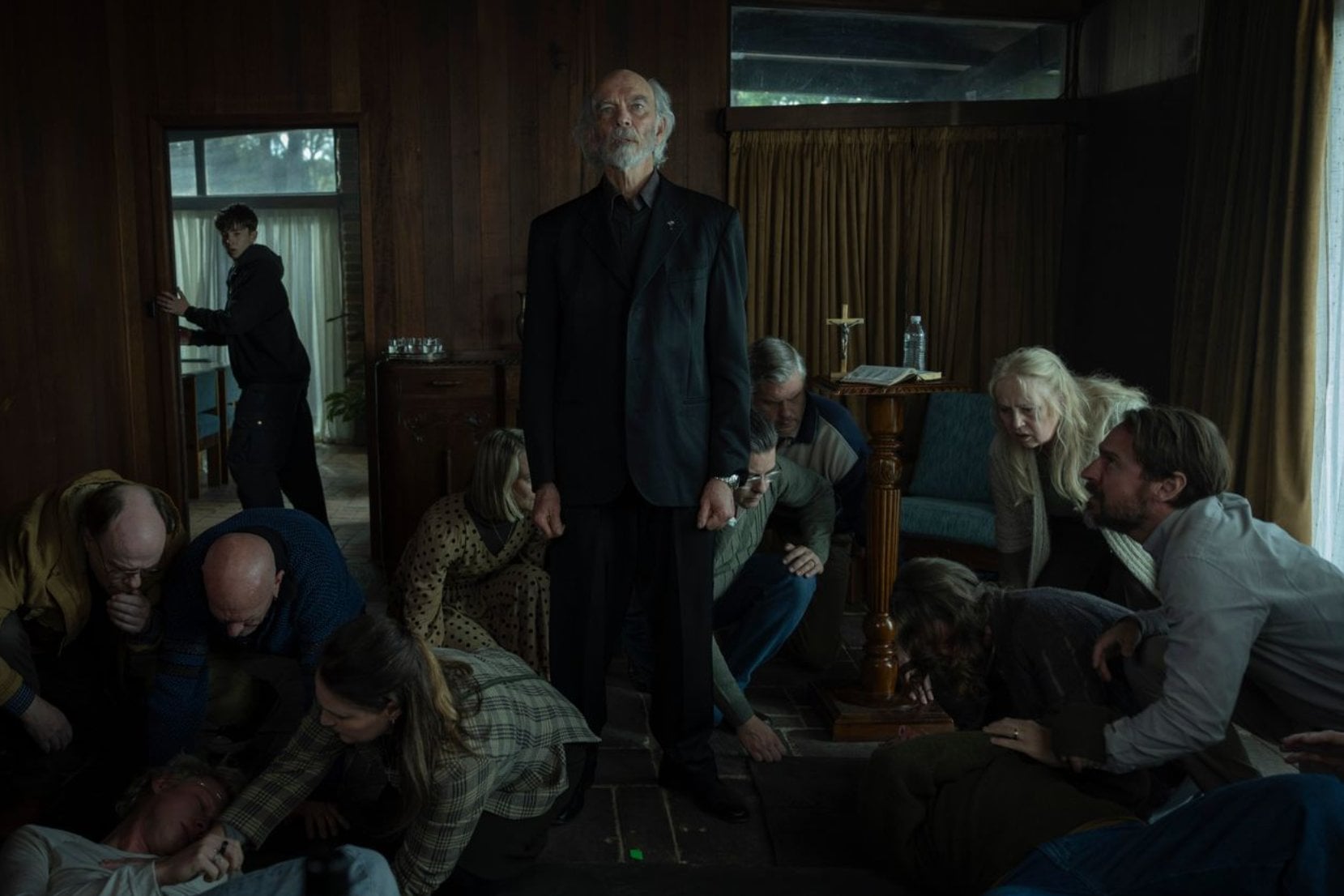 The deliverance healer (Nicholas Hope) among the congregation in "Leviticus."
