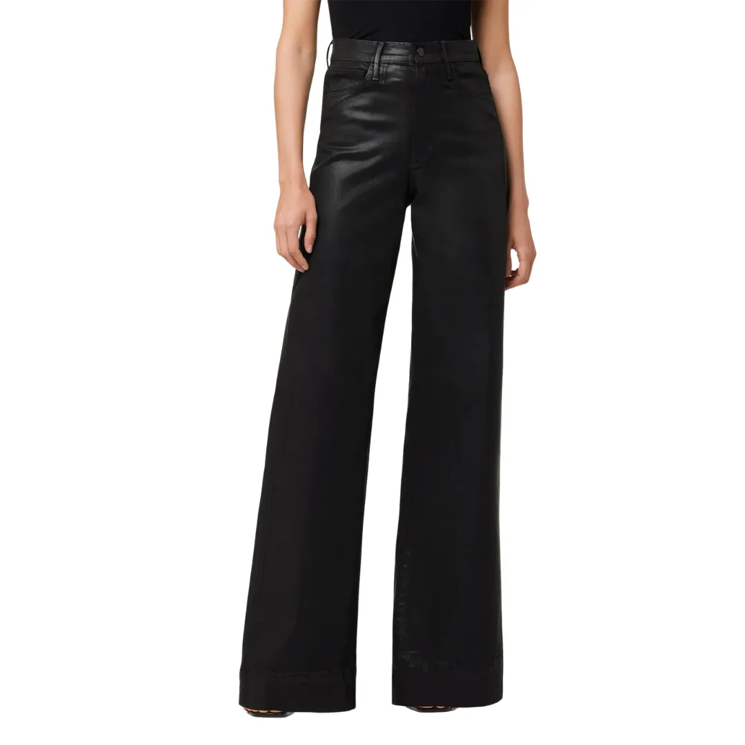 The bottom half of model wears wax-coated wide leg black trousers.
