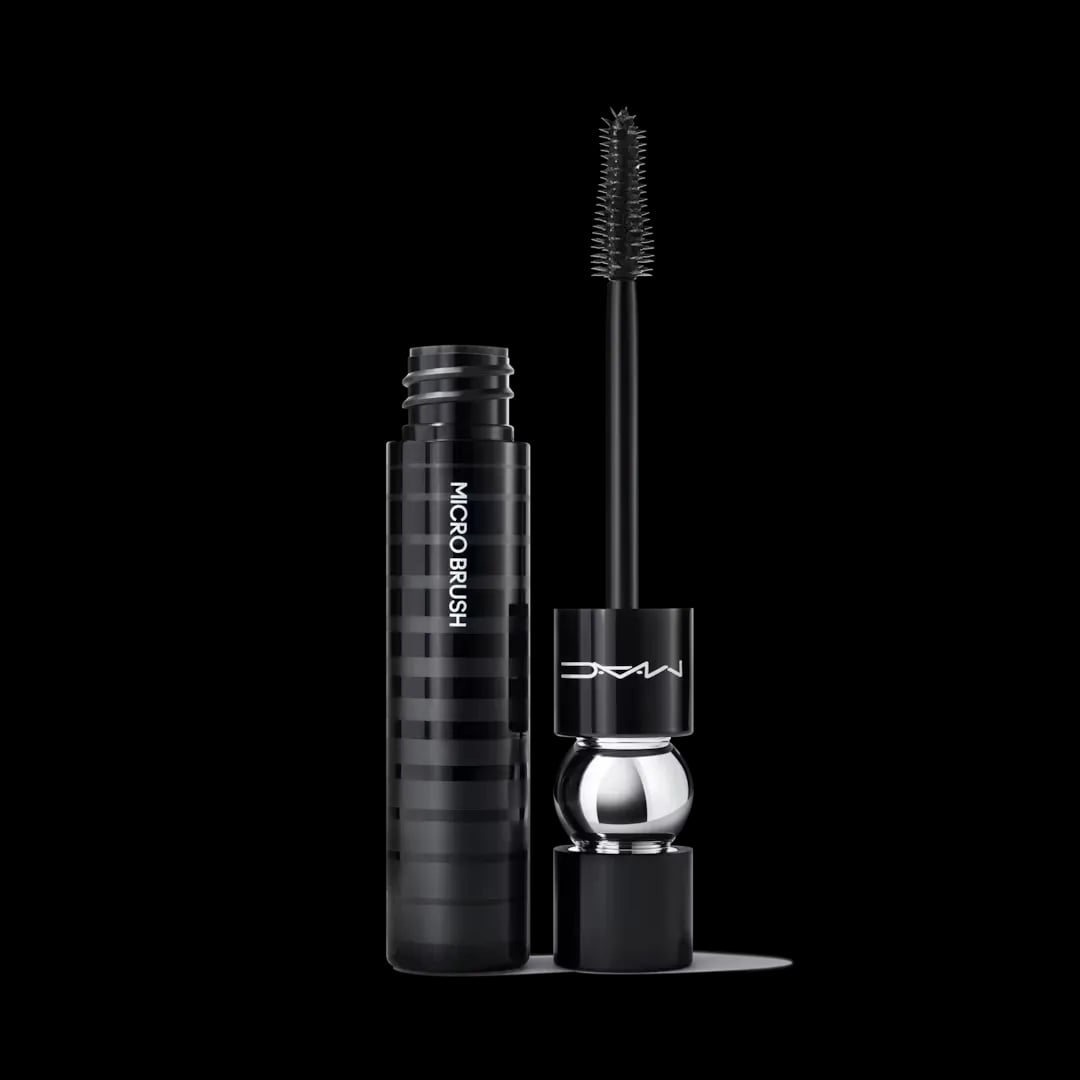 An open tube of black mascara from MAC against a light gray background