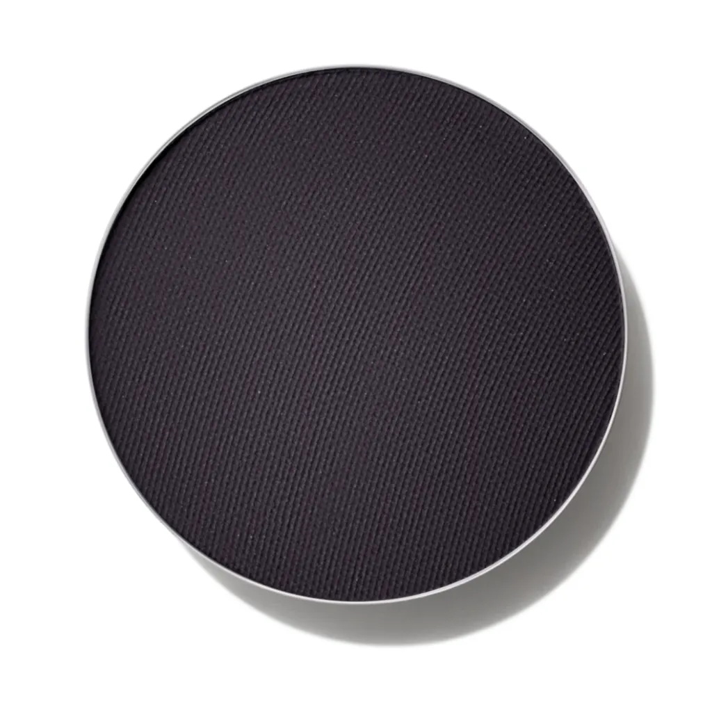 A pan of MAC Eye Shadow in Carbon, a rich black color, against a white background