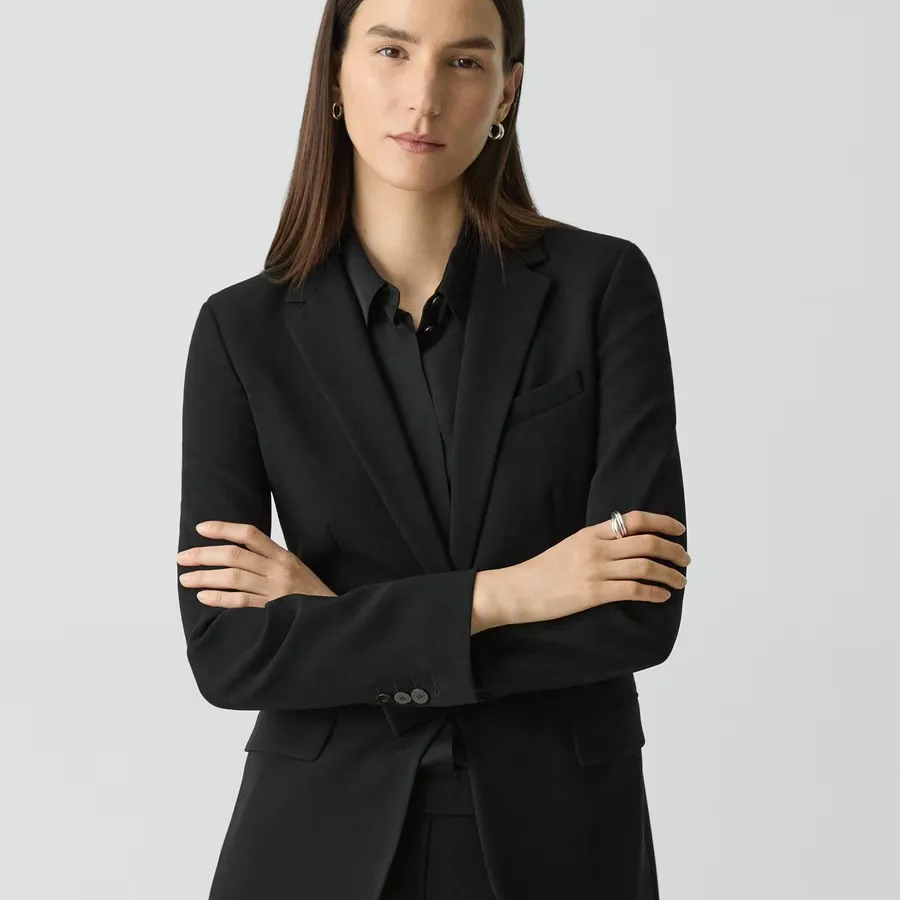 A model with her arms folded wearing the Theory Staple Blazer in Admiral Crepe in black