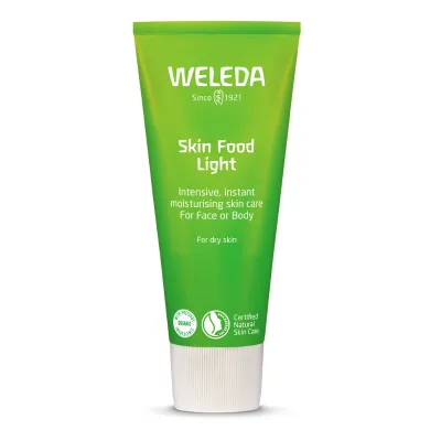 A green tube of Weleda Skin Food Light Cream against a white background