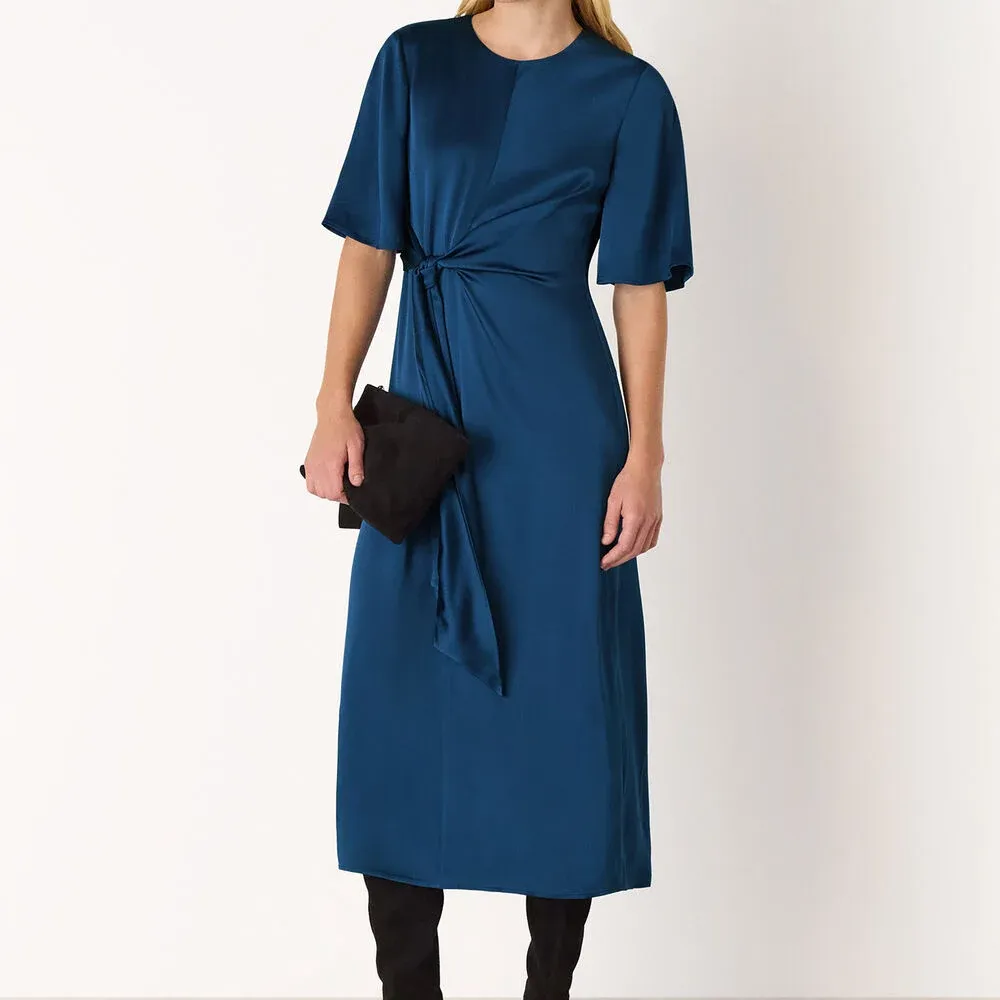 A model wears the Whistles Blue Satin Twist Waist Midi Dress in dark blue